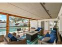 Relaxing covered patio with cozy seating, fire pit, and view of the backyard pool at 1407 E Laguna Dr, Tempe, AZ 85282