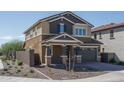 Two-story home featuring a two-car garage, desert landscaping and a block wall at 16213 W Soft Wind Dr, Surprise, AZ 85387