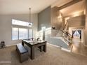 Bright living room features vaulted ceiling, large windows, pool table, and stairway access to the second floor at 17311 N Kimberly Way, Surprise, AZ 85374