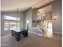 Spacious living area with high ceilings, staircase, neutral decor, and large windows overlooking the backyard at 17311 N Kimberly Way, Surprise, AZ 85374