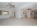 Spacious living room featuring tile floors, bright light, and ceiling fans at 18835 N Palomar Dr, Sun City West, AZ 85375