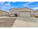 Inviting single-story home boasting a two-car garage, complemented by stone accents and low-maintenance landscaping at 2213 E Constance Way, Phoenix, AZ 85042
