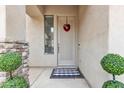 Welcoming front entrance showcasing a stylish door, decorative wreath, and manicured greenery at 2213 E Constance Way, Phoenix, AZ 85042