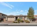 Charming single-story home featuring a neutral color scheme, a three car garage and manicured landscaping at 2254 E Tomahawk Dr, Gilbert, AZ 85298