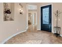 Warm foyer featuring tile flooring, a decorative front door, and views into the adjacent rooms at 2254 E Tomahawk Dr, Gilbert, AZ 85298
