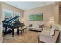 Elegant living room showcasing a grand piano, tile flooring, and classic furnishings at 2254 E Tomahawk Dr, Gilbert, AZ 85298