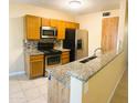 Cozy kitchen featuring stainless steel appliances, granite countertops and decorative backsplash at 255 S Kyrene Rd # 115, Chandler, AZ 85226