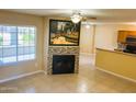 Bright living room features a fireplace, a large window and seamless access to the kitchen at 255 S Kyrene Rd # 115, Chandler, AZ 85226
