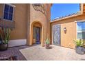 Charming courtyard with brick pavers, potted plants, and an inviting entrance to the home at 3016 N Glenview --, Mesa, AZ 85213