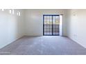 A bright and spacious bedroom with a glass sliding door to a balcony at 3434 E Baseline Rd # 213, Phoenix, AZ 85042