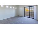 A bedroom that features carpeted floors and a glass sliding door leading to the outside at 3434 E Baseline Rd # 213, Phoenix, AZ 85042