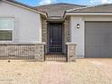 The front door features stone columns and a brick walkway with low decorative fencing at 4029 S 176Th Dr, Goodyear, AZ 85338