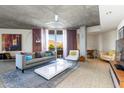 Modern living room with a concrete ceiling, neutral furniture, and a stunning view of the desert landscape at 6850 E Main St # 4416, Scottsdale, AZ 85251