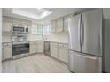 Bright kitchen featuring stainless steel appliances, white cabinetry, and a skylight at 6885 E Cochise Rd # 219, Paradise Valley, AZ 85253