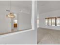 Light and airy living room with neutral carpet and an ornate chandelier at 8096 E Lavender Dr, Gold Canyon, AZ 85118