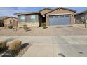 A cozy house featuring a charming stone accent, low-maintenance landscaping, and a convenient two-car garage at , Maricopa, AZ 85138