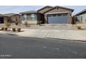 Street view of a single-story home with a blue garage door and low-maintenance rock landscaping at , Maricopa, AZ 85138