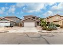 Inviting two-story home featuring a well-maintained front yard and desert landscaping at 1135 E Desert Holly Dr, San Tan Valley, AZ 85143