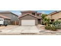 Attractive two-story home featuring a clean white garage door and desert landscaping at 1135 E Desert Holly Dr, San Tan Valley, AZ 85143