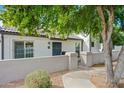 Single level home featuring a front courtyard with gated entry and easy-care landscaping at 1180 E Belmont Ave, Phoenix, AZ 85020