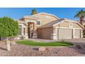 Charming single Gathering home with a well-manicured lawn and desert landscaping at 1321 N Bronco Ct, Gilbert, AZ 85233