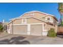 A three-car garage with neutral doors adds space and function to this lovely home at 1321 N Bronco Ct, Gilbert, AZ 85233