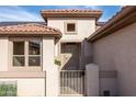 Close-up of the front entrance with a security gate and small decorative window above the doorway at 15864 W Clearwater Way, Surprise, AZ 85374