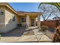 Inviting front porch with stylish columns and desert landscaping for enhanced curb appeal at 16875 W Manchester Dr, Surprise, AZ 85374