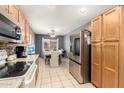 Eat in kitchen with stainless steel appliances and a dining area with natural light at 19863 N Emmerson Dr, Maricopa, AZ 85138