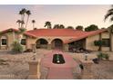 Inviting front yard featuring desert landscaping, a red walkway and a welcoming entrance with arched openings at 2107 E Inca St, Mesa, AZ 85213