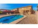 Enjoy a refreshing dip in this backyard pool, surrounded by a patio, ideal for outdoor relaxation and entertaining at 22157 W Moonlight Path, Buckeye, AZ 85326