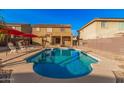 Beautiful backyard pool with ample space, perfect for relaxation and fun in the sun with patio furniture at 22157 W Moonlight Path, Buckeye, AZ 85326