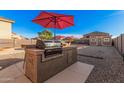 Backyard grill station with built-in barbecue, ideal for outdoor cooking and entertaining in the backyard at 22157 W Moonlight Path, Buckeye, AZ 85326