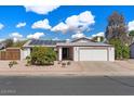 Charming single-story home with a well-manicured front yard, showcasing curb appeal at 2230 W Peralta Ave, Mesa, AZ 85202