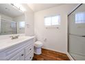 Clean bathroom features a vanity with storage, a toilet, and a glass-enclosed shower at 2326 E Waltann Ln, Phoenix, AZ 85022