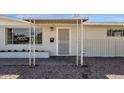 Cozy front porch with a decorative screen door, matching columns, and freshly painted brick at 2545 E Amelia Ave, Phoenix, AZ 85016