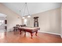 Bright, open living space with a pool table, hardwood floors, high ceiling and a pool view at 2621 E Stottler Dr, Gilbert, AZ 85296