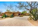 Stately home with a circular drive and mature desert landscaping at 27903 N Agua Verde Dr, Rio Verde, AZ 85263