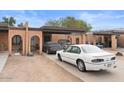 The front exterior of the brick home features a carport and driveway with multiple vehicles parked on the property at 331 S Beck Ave, Tempe, AZ 85281