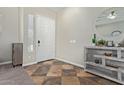 Welcoming entryway with tiled floor, decorative console table, and ample natural light at 3344 E Grand Canyon Dr, Chandler, AZ 85249