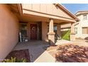 Inviting front porch with decorative wreath, charming seating, and manicured shrubbery at 3344 E Grand Canyon Dr, Chandler, AZ 85249