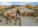 Attractive single-story home showcasing desert landscaping, spacious driveway, and a two-car garage at 33705 N 64Th St, Scottsdale, AZ 85266