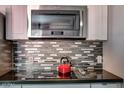 Modern kitchen featuring stainless steel appliances and stylish backsplash, and a dark countertop at 461 W Holmes Ave # 308, Mesa, AZ 85210