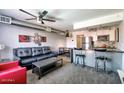 Open-concept living room with stylish furnishings, kitchen with breakfast bar, and dining area at 461 W Holmes Ave # 308, Mesa, AZ 85210
