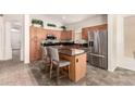 A well-lit kitchen featuring granite countertops, stainless steel appliances, and an eat-in island at 4881 W Flint St, Chandler, AZ 85226