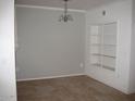 This is an empty dining room with a large window, tile floor, and an ornate chandelier at 5345 E Van Buren St # 111, Phoenix, AZ 85008