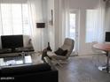 Bright living room boasting a minimalist design, large windows, and an open floor plan at 5345 E Van Buren St # 111, Phoenix, AZ 85008
