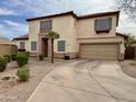 Front exterior view showcasing a two-story home with a tile roof, manicured landscaping, and a long driveway at 671 E Colt Ct, Chandler, AZ 85225