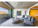 Open living space with modern furnishings, gray sofa, concrete ceilings, and sliding doors to a balcony with mountain views at 6850 E Main St # 4404, Scottsdale, AZ 85251
