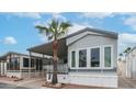 Charming single-story home featuring a carport, desert landscaping, and palm tree at 711 Felspar Dr, Apache Junction, AZ 85119